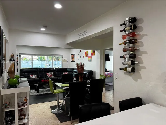 a living room with furniture a rug and a flat screen tv