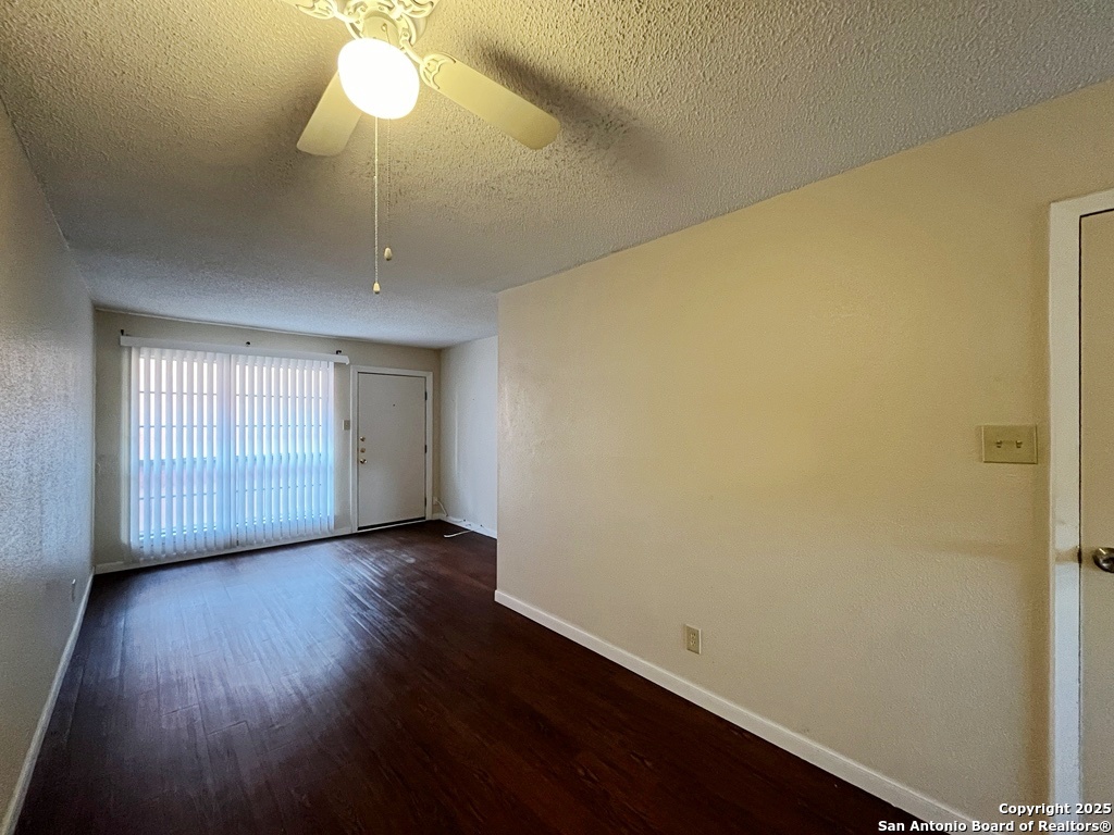 3243 Nacogdoches Road, Unit 404 San Antonio, TX 78217 - Photo 11 of 30 an empty room with wooden floor fan and windows