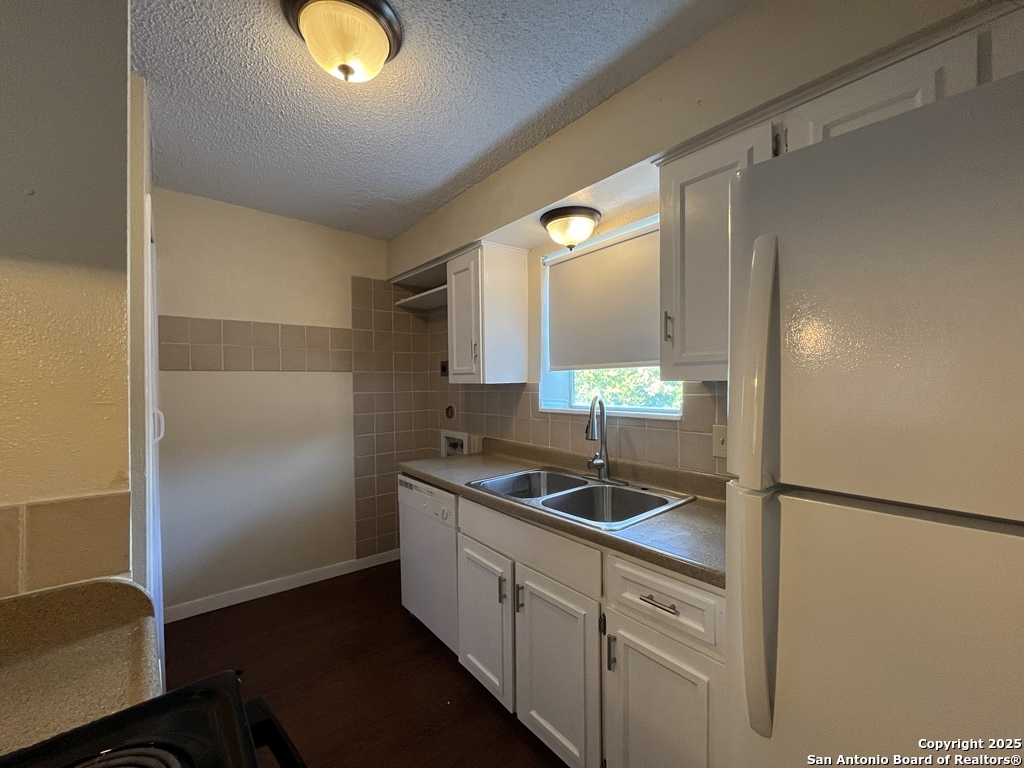 3243 Nacogdoches Road, Unit 404 San Antonio, TX 78217 - Photo 14 of 30 a kitchen with a sink and cabinets