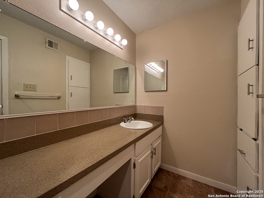 3243 Nacogdoches Road, Unit 404 San Antonio, TX 78217 - Photo 21 of 30 a bathroom with a sink and a mirror