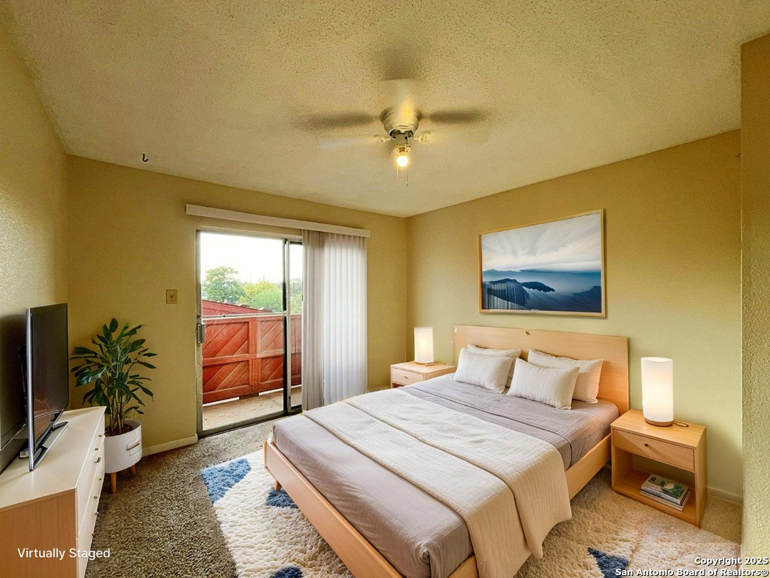 3243 Nacogdoches Road, Unit 404 San Antonio, TX 78217 - Photo 4 of 30 a bedroom with a bed and a flat screen tv