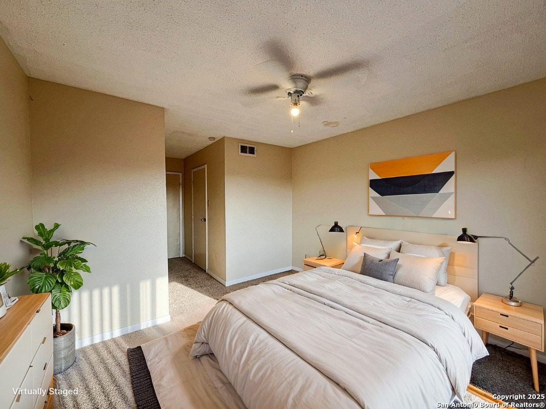 3243 Nacogdoches Road, Unit 404 San Antonio, TX 78217 - Photo 5 of 30 a bedroom with a bed and a potted plant