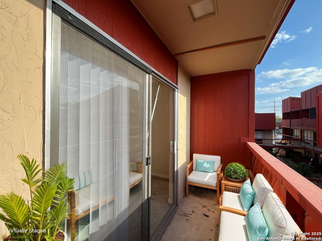 3243 Nacogdoches Road, Unit 404 San Antonio, TX 78217 - Photo 6 of 30 a balcony with furniture and a potted plant