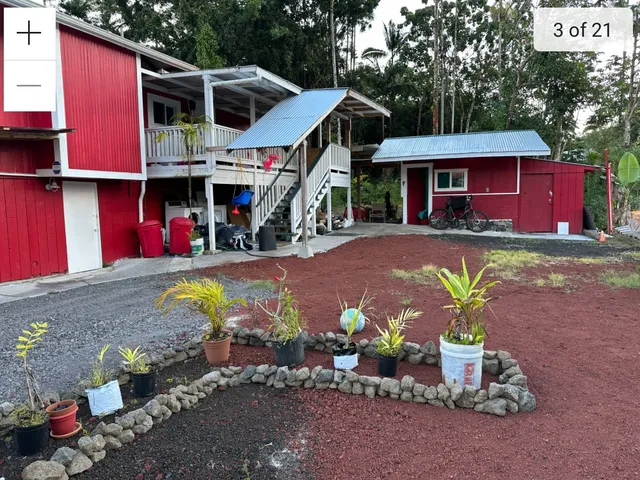 a view of a chairs and table in the backyard