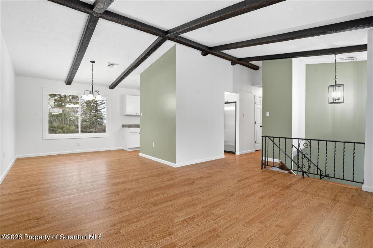 847 Griffin Pond Road Clarks Summit, PA 18411 - Photo 13 of 57 a view of an empty room with wooden floor and a window