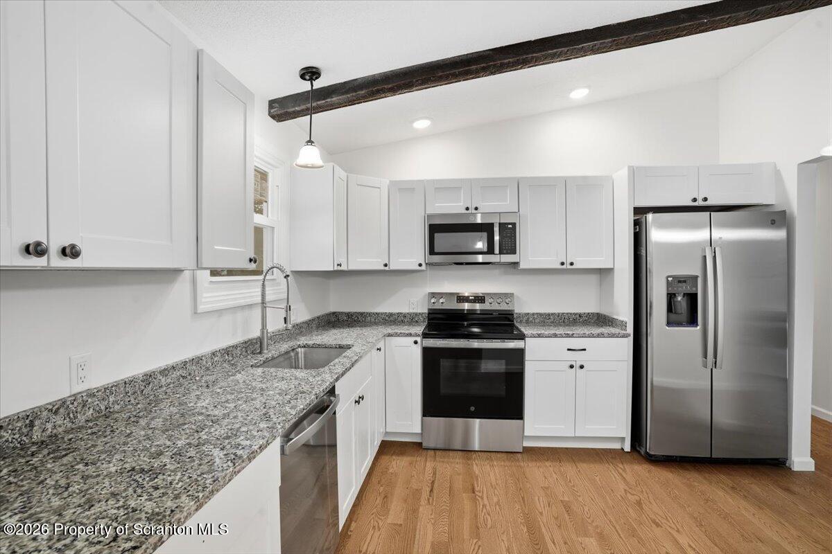 847 Griffin Pond Road Clarks Summit, PA 18411 - Photo 17 of 57 a kitchen with stainless steel appliances granite countertop a refrigerator a stove a sink and a microwave