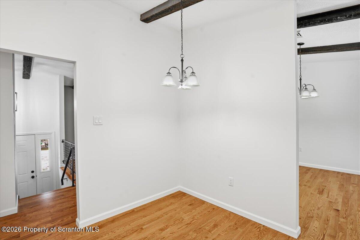 847 Griffin Pond Road Clarks Summit, PA 18411 - Photo 21 of 57 a view of a room with wooden floor and a ceiling fan