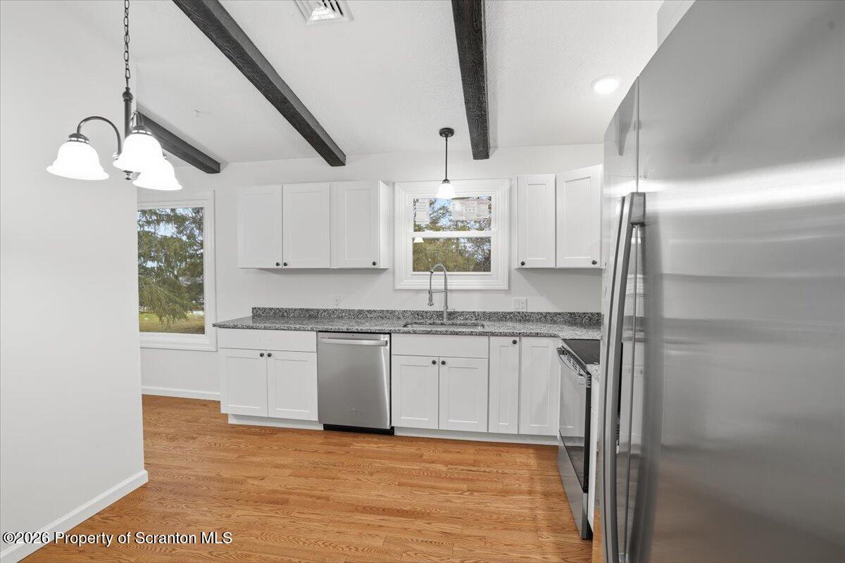847 Griffin Pond Road Clarks Summit, PA 18411 - Photo 22 of 57 a kitchen with stainless steel appliances granite countertop a sink and a refrigerator