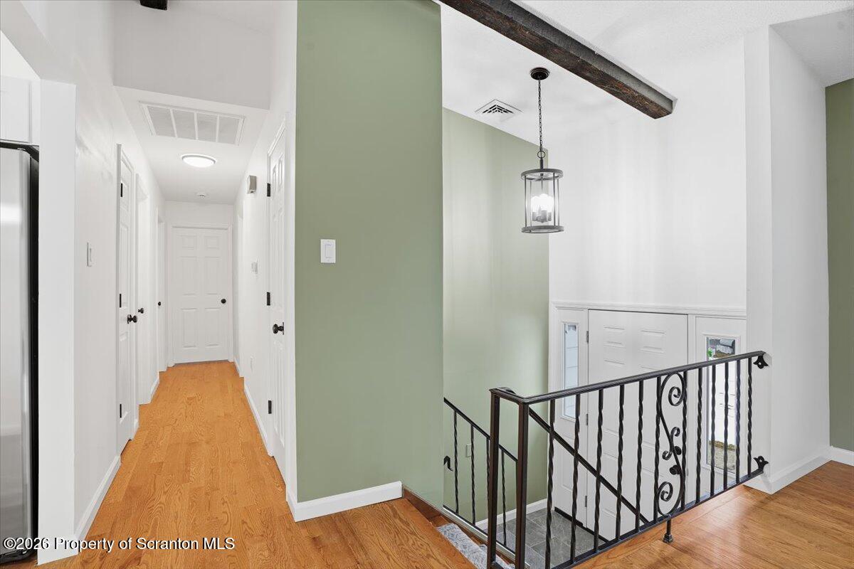 847 Griffin Pond Road Clarks Summit, PA 18411 - Photo 23 of 57 a view of a hallway with wooden floor and staircase