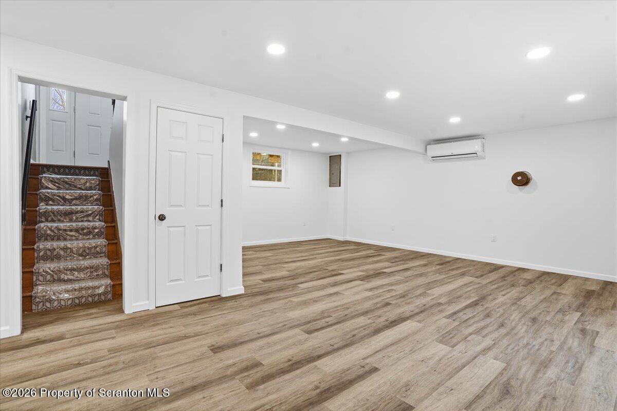 847 Griffin Pond Road Clarks Summit, PA 18411 - Photo 36 of 57 an empty room with wooden floor and windows