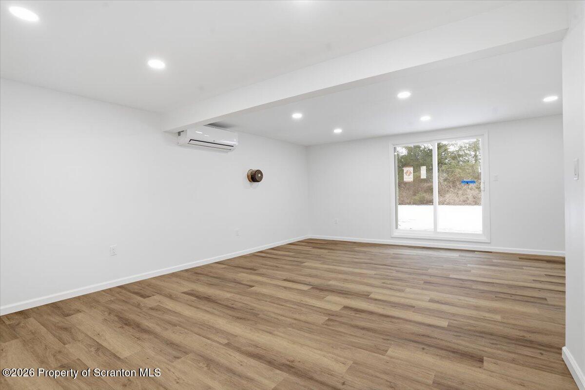 847 Griffin Pond Road Clarks Summit, PA 18411 - Photo 39 of 57 a view of an empty room with wooden floor and a window