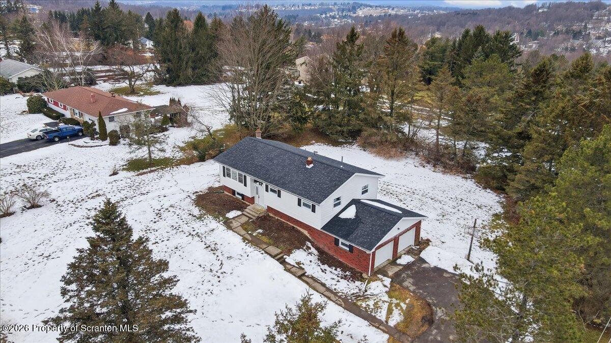 847 Griffin Pond Road Clarks Summit, PA 18411 - Photo 5 of 57 an aerial view of a house with a yard and mountain view in back