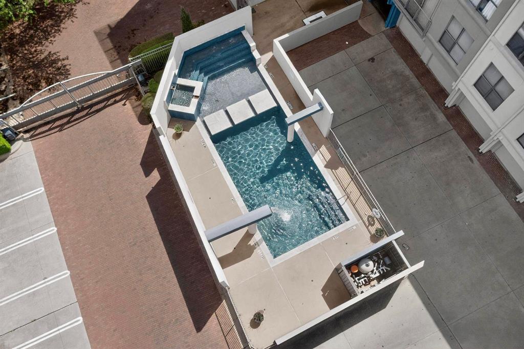 4414 Cedar Springs Road, Unit 318 Dallas, TX 75219 - Photo 13 of 40 Two-tiered swimming pool with integrated spa and multiple diving boards, complemented by a dedicated outdoor cooking area