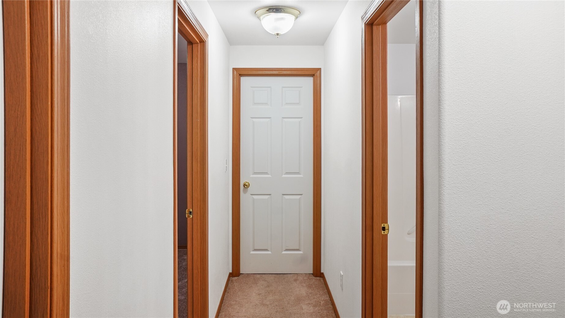 940 Capstone Avenue Othello, WA 99344 - Photo 17 of 25 a view of a hallway with wooden floor