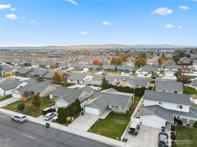 an aerial view of residential houses with outdoor space