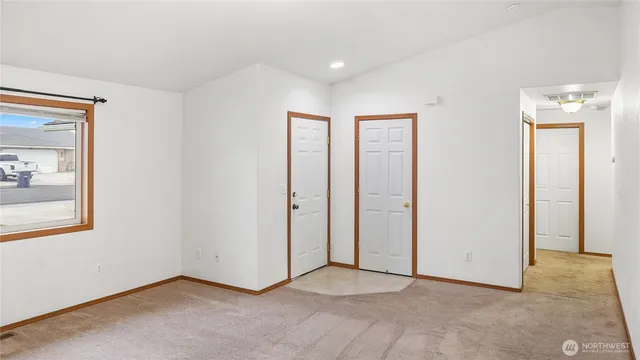 an empty room with windows and closet