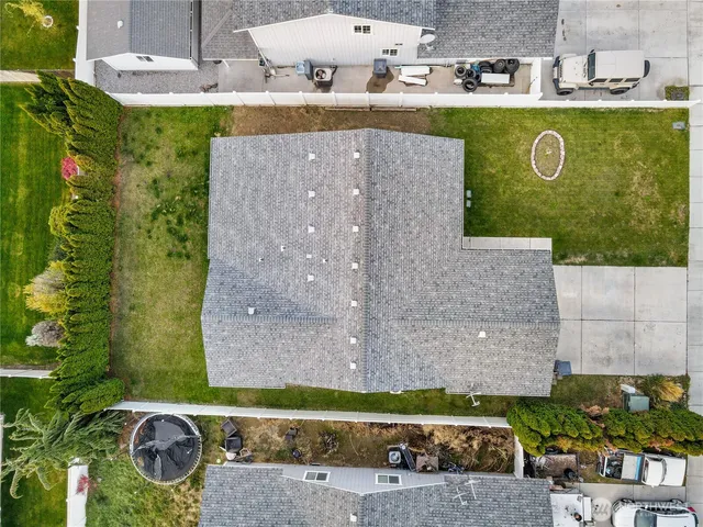 an aerial view of a house with a yard