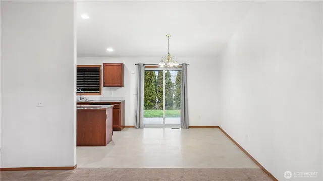 a view of a kitchen with a sink and dishwasher wooden floor