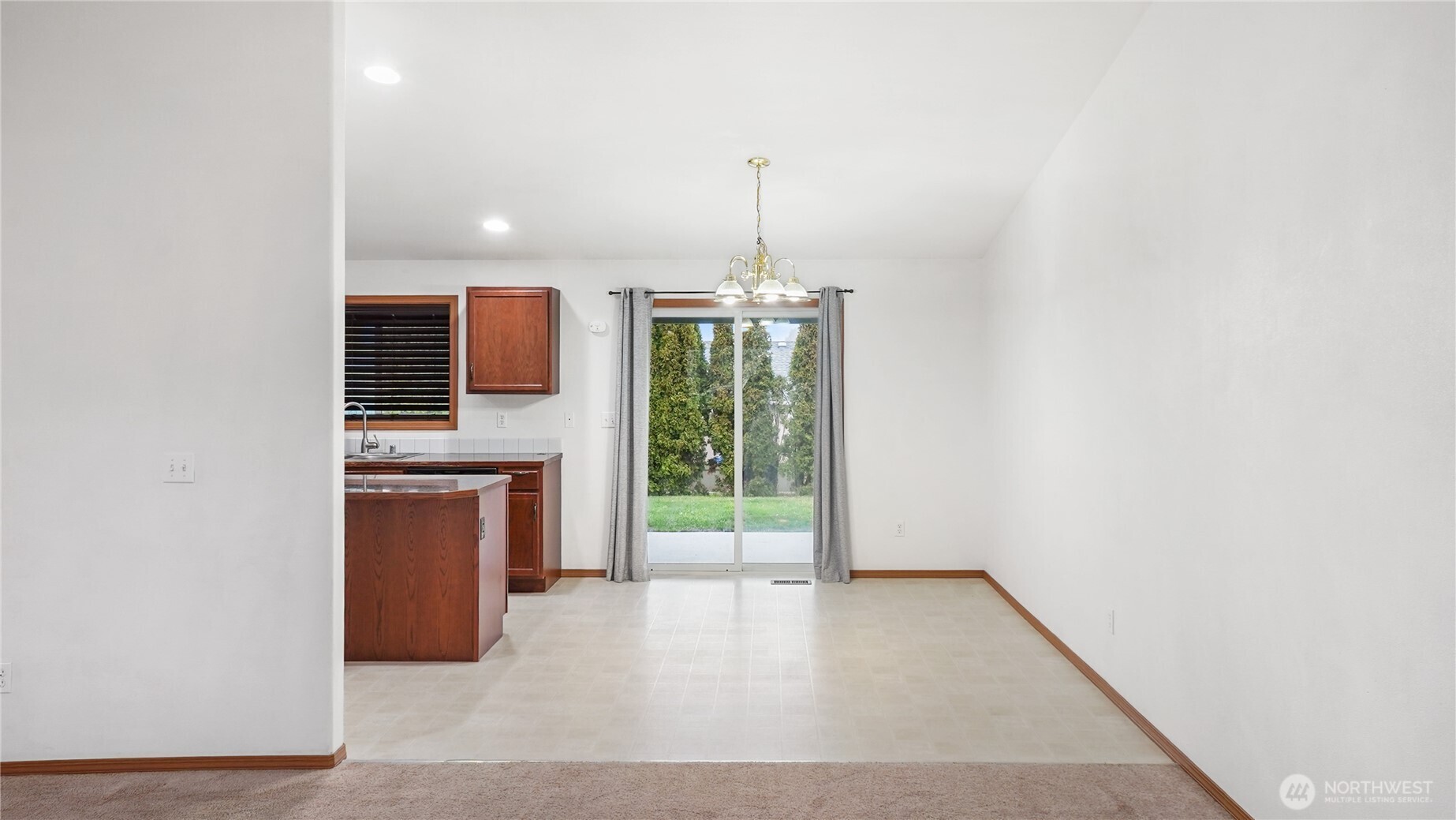 940 Capstone Avenue Othello, WA 99344 - Photo 9 of 25 a view of a kitchen with a sink and dishwasher wooden floor