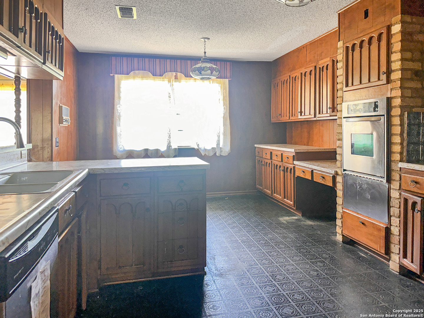 9107 Old Mill Road San Antonio, TX 78230 - Photo 13 of 14 a kitchen with stainless steel appliances granite countertop a sink and a stove