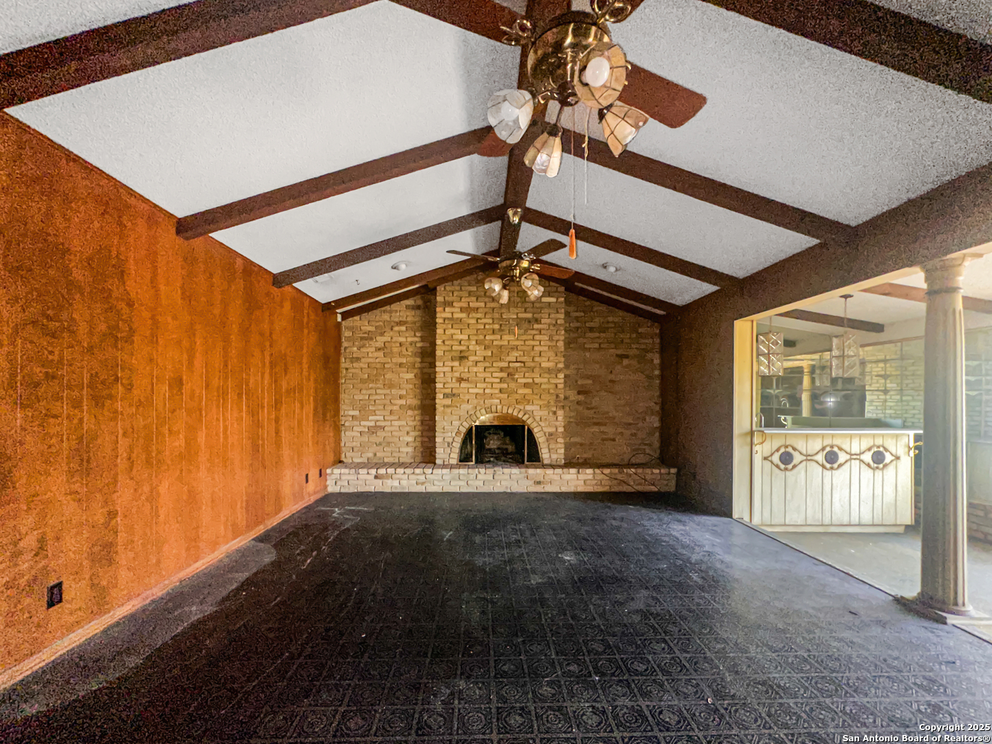 9107 Old Mill Road San Antonio, TX 78230 - Photo 4 of 14 a view of an empty room with a fireplace and a window