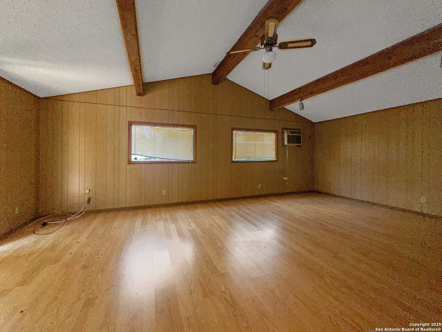 9107 Old Mill Road San Antonio, TX 78230 - Photo 6 of 14 an empty room with wooden floor and windows