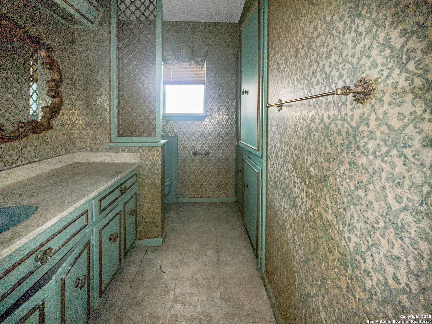 9107 Old Mill Road San Antonio, TX 78230 - Photo 10 of 14 a bathroom with a granite countertop shower and a sink