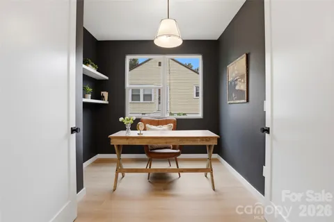 a view of a dining room with a table and chairs
