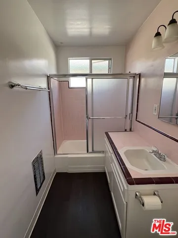 an empty room with wooden floor and closet