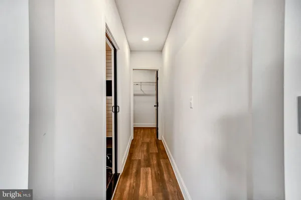 a view of a hallway with wooden floor