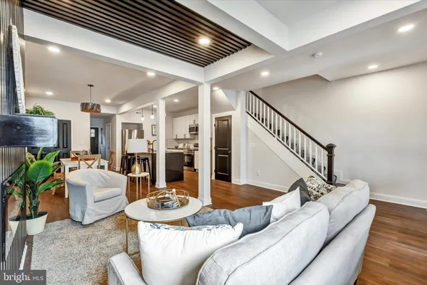 a living room with furniture and a chandelier