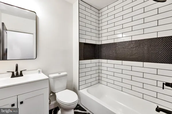 a bathroom with a bathtub and a toilet