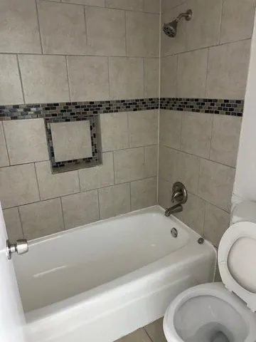 a bathroom with a bathtub and toilet