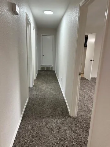 an entryway door with a hallway in the house