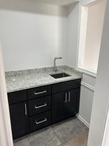 a kitchen with a sink and a mirror