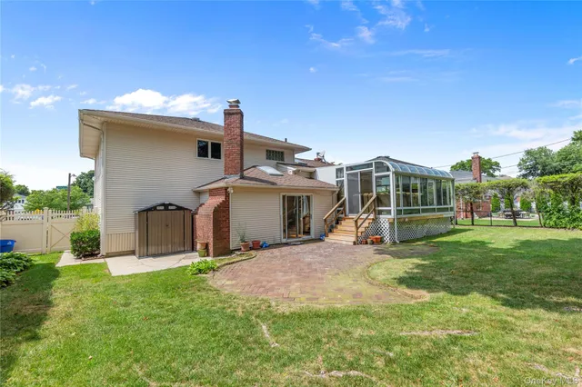 a view of a house with yard and a garden