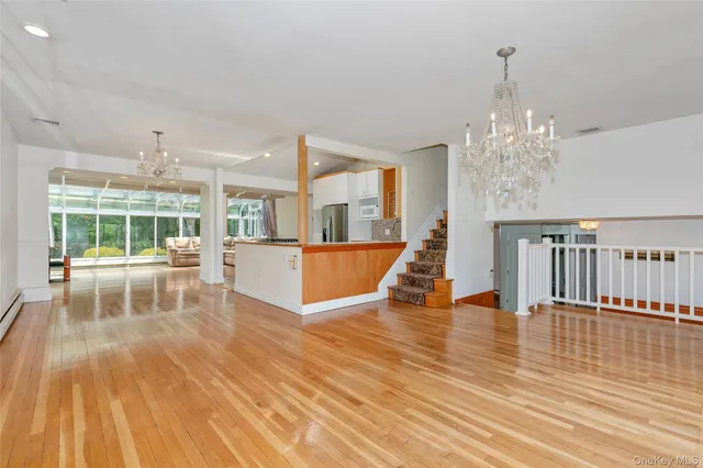 a view of a living room and kitchen with a floor to ceiling window