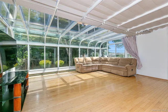 a view of a patio with a table and chairs next to a yard