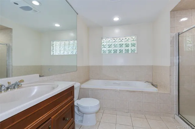 a bathroom with a sink a toilet and bathtub