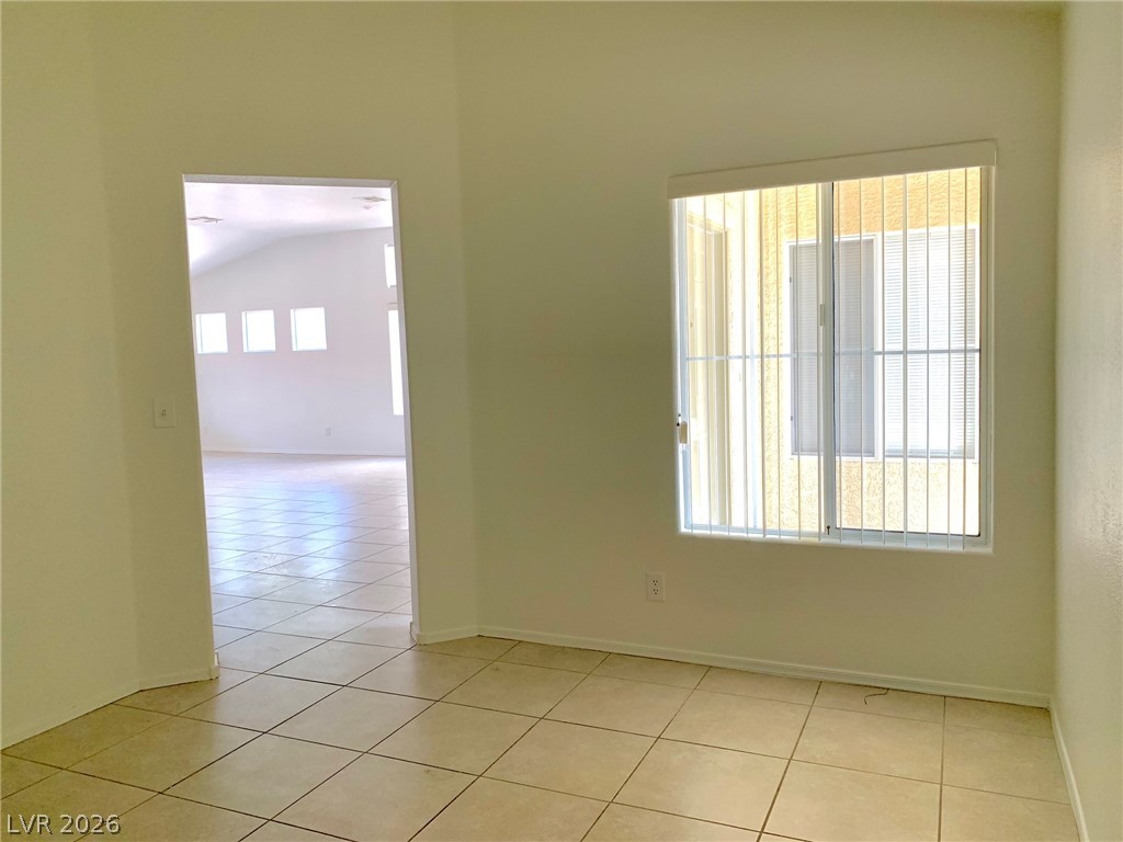 3821 Bombastic Court Las Vegas, NV 89147 - Photo 10 of 36 This bright room features durable tile flooring and abundant natural light through its window.