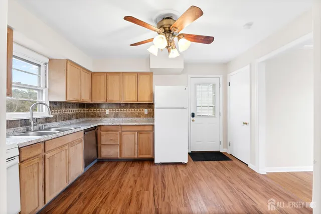 a kitchen with a refrigerator and white cabinets