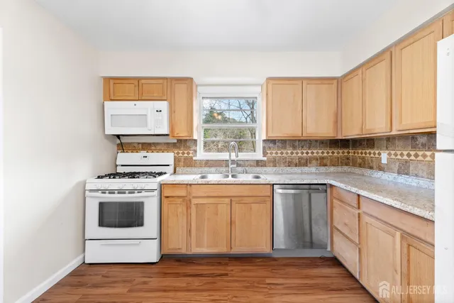 a kitchen with stainless steel appliances a stove a sink and a microwave