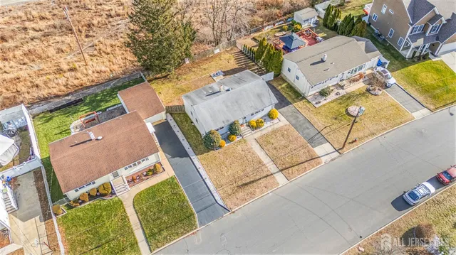 an aerial view of a house with a yard