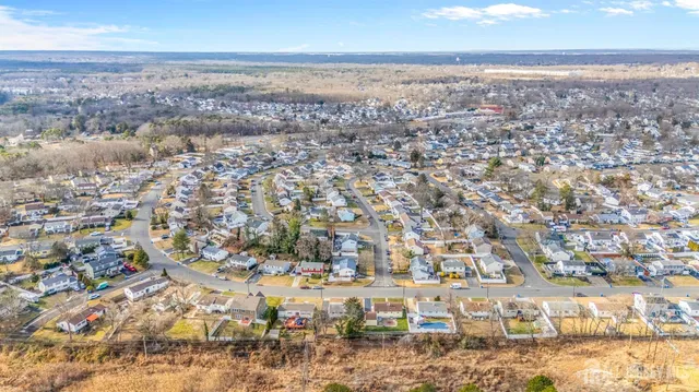 an aerial view of residential building with green space