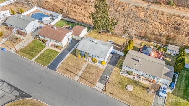 an aerial view of residential house with outdoor space and parking