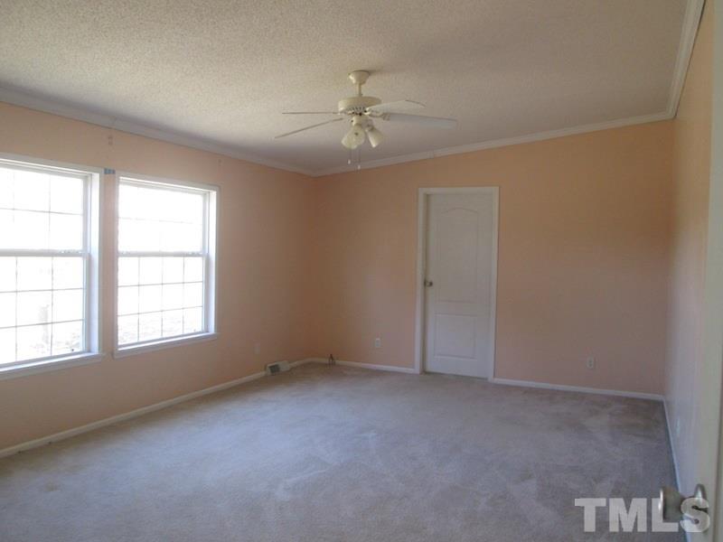 507 Line Road Cameron, NC 28326 - Photo 10 of 11 an empty room with a window and ceiling fan