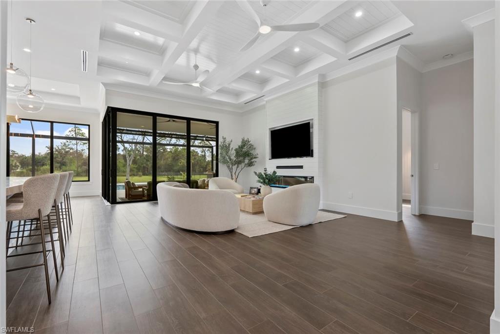 722 19th Street Southwest Naples, FL 34117 - Photo 12 of 47 Living room with coffered ceiling, beam ceiling, dark wood-type flooring, and a high ceiling