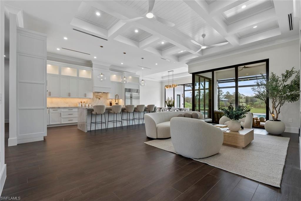 722 19th Street Southwest Naples, FL 34117 - Photo 10 of 47 Living room featuring coffered ceiling, dark wood-type flooring, beamed ceiling, and ceiling fan