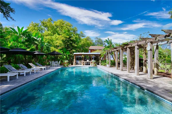 a view of a backyard with sitting area