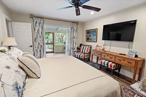 a bedroom with furniture and a flat screen tv
